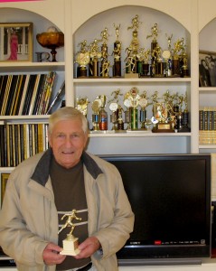 My dad with his running trophies